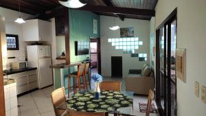 a kitchen and dining room with a table and chairs at Apto estilo chalé em Ponta Negra in Natal