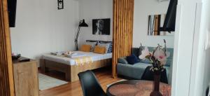 a living room with a bed and a mirror at Over the City in Oradea