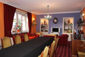 a living room with a large table and chairs at Cit'Hotel Marie Stuart in La Roche-sur-Yon +23 photos