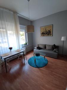a living room with a couch and a table at EVA Apartment in Novi Sad