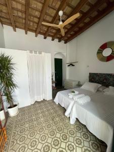 a bedroom with a bed and a ceiling at Doña Lola Rooms in Conil de la Frontera