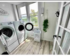 a laundry room with a washing machine and a window at 8-A Diamond in Yonkers, NY in Yonkers
