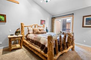 a bedroom with a wooden bed and a window at Summit Condo - Luxury condo, walk to the slopes! in Big Bear Lake