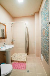 uma casa de banho com um chuveiro, um lavatório e um WC. em Boutique hotel Shakh em Bucara