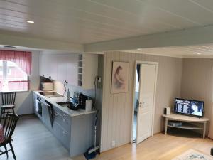 a kitchen with a sink and a counter top at Feriebolig på bygda in Straumsjøen
