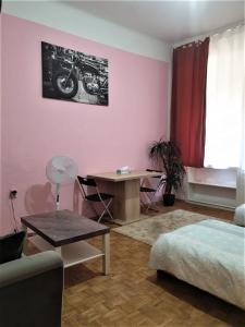 a bedroom with a bed and a desk with a motorcycle on the wall at near the center in Vienna
