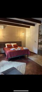 a bedroom with a large bed with red sheets and pillows at La Villa Manee in La Saline les Bains