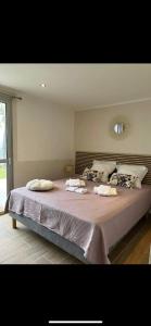 a bedroom with a large bed with towels on it at La Villa Manee in La Saline les Bains