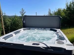a hot tub sitting on top of a field at Au Coin Du Belvédère in Saint Come +36 photos
