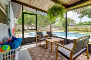 a patio with chairs and a table and a swimming pool at Uncle Louies Gulf Coast Retreat with Outdoor Oasis! in Bradenton