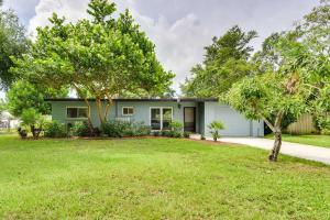 a house with a lawn in front of it at Uncle Louies Gulf Coast Retreat with Outdoor Oasis! in Bradenton