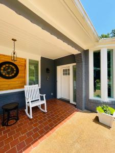 a porch with a white bench on a house at Sonsak - Unit 2 in Charlottesville