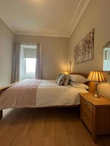 a bedroom with a large bed and a window at Luxury Victorian spacious flat in Glasgow