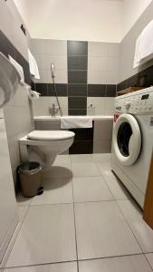 a bathroom with a washing machine and a washer at Apartmán III Praha - centrum in Prague