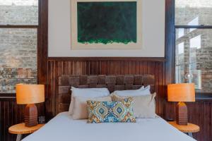 a bedroom with a large bed with two lamps at Fire Station One Boutique Hotel in Roanoke