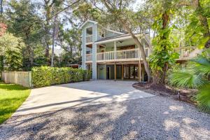 a large house with a porch and a driveway at Private Saltwater Pool Stunning Seminole Stay! in Redington Shores