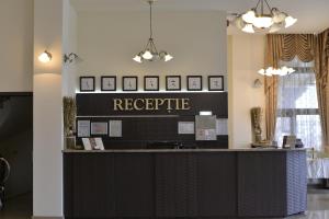 a lobby with a reception counter with a sign that reads recycle at Hotel Miky in Arad
