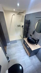 a bathroom with a black sink and a shower at Penzion Loket in Loket +42 photos