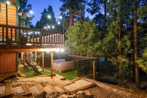 a backyard with a deck and a house at Pine Den Cabin: Arcade+Fire Pit+BBQ in Sugarloaf