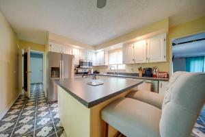 a kitchen with white cabinets and a counter top at Richmond Heights Retreat with Patio and Fire Pit! in Richmond Heights