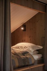 a bedroom with a bunk bed and pillows at Tuftegarden in Viksdalen