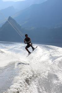 a man water skiing in the ocean while holding onto a rope at Summer C in Macanal +38 photos