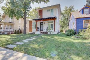 a house with a lawn in front of it at Modern Lawrence Home with Patio Less Than Half-Mi to U of K! in Lawrence