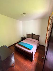 a bedroom with a bed in a room at Chale das hortensias in Petrópolis