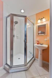 a bathroom with a glass shower and a sink at Nw Resort Condo W Stunning Ocean Views in North Wildwood