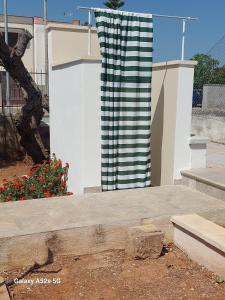 a black and white column in front of a building at tata Uccio in Matino +26 photos