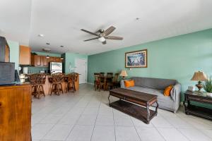 a living room with a couch and a table and a kitchen at Nw Resort Condo W Stunning Ocean Views in North Wildwood