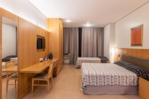 A bed or beds in a room at DELPLAZA Excelsior São Paulo - By Monreale