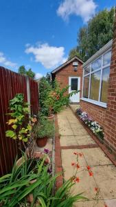 a garden in front of a house with plants at Glebe House, Private entrance, free parking on drive, Self check in, Netflix in Ashford