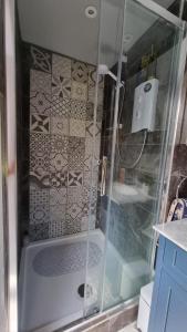 a shower with a glass door in a bathroom at Glebe House, Private entrance, free parking on drive, Self check in, Netflix in Ashford