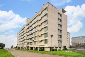 un grande edificio bianco su una strada con un prato di Ocean Front 2bed Luxury w/ Elevator Parking WI-FI a Matosinhos