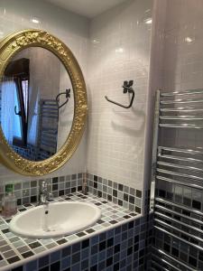 a bathroom with a sink and a mirror at La Casa de Fefita (Stone house in a privileged environment 35 km from Bilbao) 