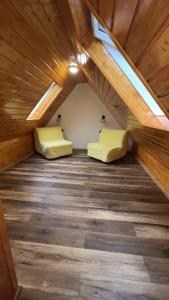 an attic room with two beds and a window at Penzion Loket in Loket