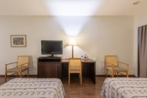 A bed or beds in a room at DELPLAZA Excelsior São Paulo - By Monreale