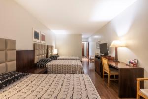 A bed or beds in a room at DELPLAZA Excelsior São Paulo - By Monreale