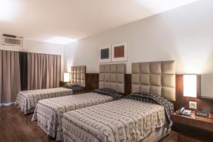 A bed or beds in a room at DELPLAZA Excelsior São Paulo - By Monreale