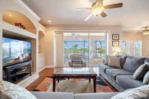 a living room with a couch and a tv at Heated Pool and Spa, Sleeps 6 - Villa Cayman in North Fort Myers