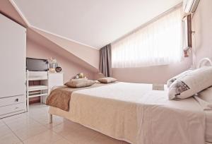 En eller flere senge i et værelse på B&B Villa Miramare