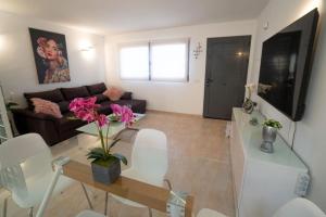 a living room with a couch and a table at Casa Alfred, El Cotillo, Best one beach to 150 m WIFI fiber in Cotillo