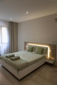 a bedroom with a large bed with lights on it at RomanApartments in Mestre
