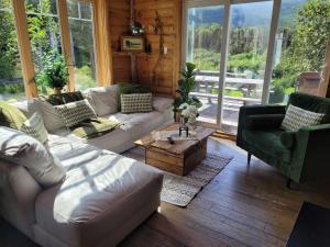 sala de estar con sofá blanco y mesa en Le Ti Moose - Les Chalets Spa Canada en La Malbaie