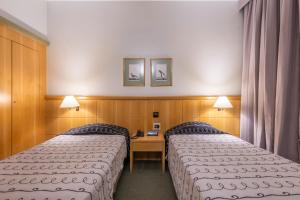 A bed or beds in a room at DELPLAZA Excelsior São Paulo - By Monreale