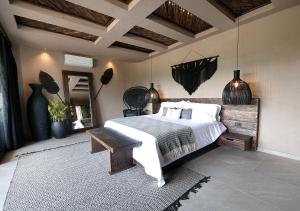 a bedroom with a large bed and a wooden table at Casa Candela in San Jerónimo