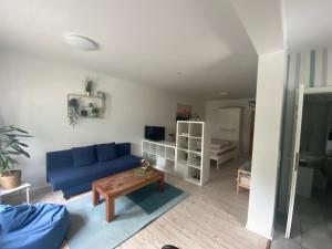 a living room with a blue couch and a table at Ferienwohnung Shakira in Penig