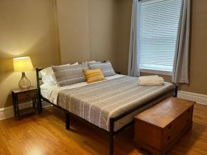 a bed sitting in a room with a window at Flat at Forest Park - Walk or Bike to Zoo! in Benton