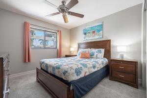 a bedroom with a bed and a ceiling fan at Half mile to the beach! Heated Pool & Spa, with Tiki on boat dock! - Villa Changes in Attitude in Cape Coral +42 photos